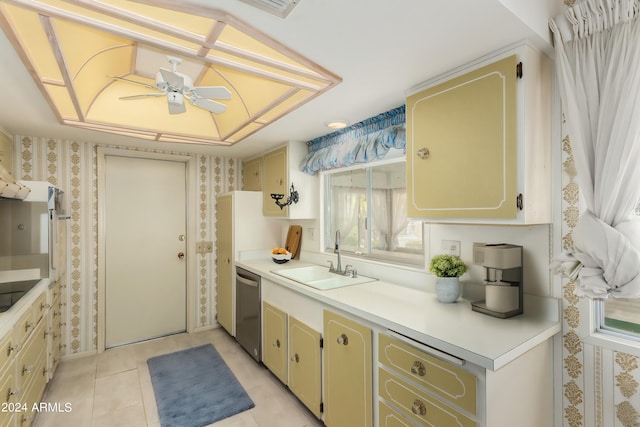 kitchen featuring sink, a raised ceiling, light tile patterned flooring, ceiling fan, and stainless steel dishwasher