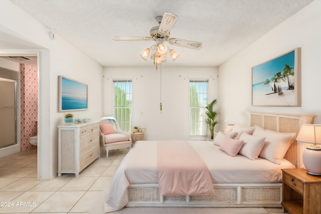 bedroom with ceiling fan and light tile patterned floors