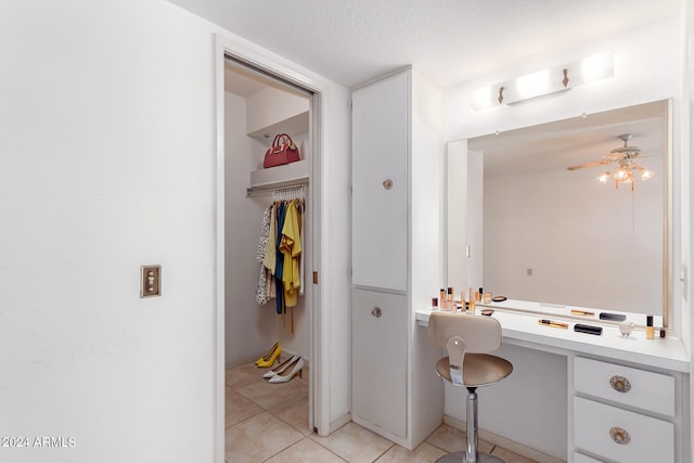 bathroom featuring ceiling fan, a textured ceiling, and tile patterned floors