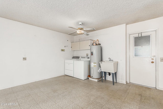 interior space with ceiling fan, sink, washer and clothes dryer, and water heater