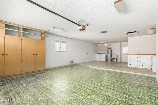 garage with independent washer and dryer, water heater, sink, ceiling fan, and a garage door opener