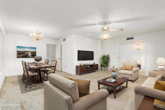 living room featuring ceiling fan with notable chandelier and light colored carpet