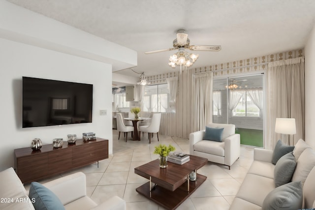 tiled living room with ceiling fan with notable chandelier