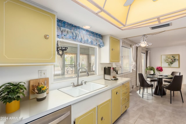 kitchen with dishwasher, light tile patterned floors, a chandelier, and sink