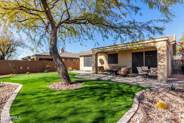 back of property with a patio area, a fenced backyard, an outdoor living space, and stucco siding