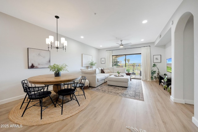 920 E Devonshire Ave Unit 4004, Phoenix, AZ 85014 - dining space with light wood-type flooring, recessed lighting, arched walkways, a ceiling fan, and a chandelier