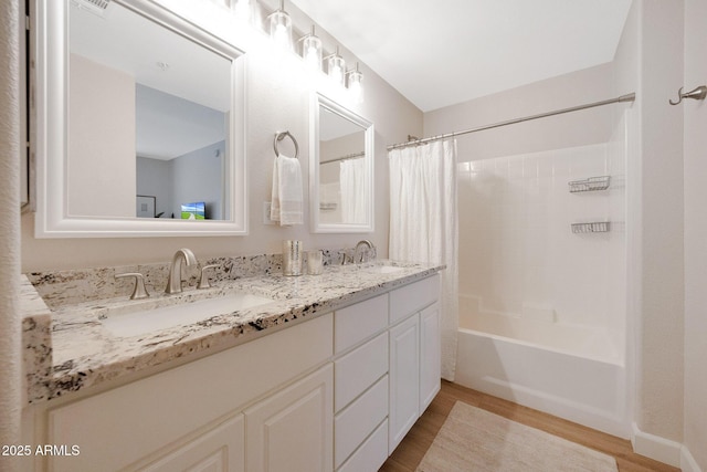 920 E Devonshire Ave Unit 4004, Phoenix, AZ 85014 - full bathroom featuring wood finished floors, double vanity, and shower / tub combo