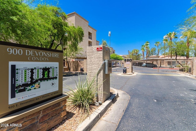 920 E Devonshire Ave Unit 4004, Phoenix, AZ 85014 - view of asphalt road with a gate, curbs, and a gated entry