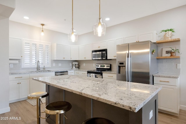 920 E Devonshire Ave Unit 4004, Phoenix, AZ 85014 - kitchen featuring appliances with stainless steel finishes, white cabinetry, decorative backsplash, and recessed lighting