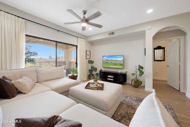 920 E Devonshire Ave Unit 4004, Phoenix, AZ 85014 - living area featuring a ceiling fan, arched walkways, wood finished floors, and recessed lighting
