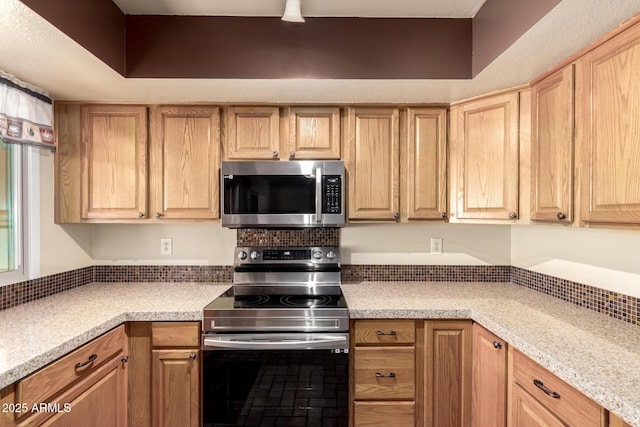 kitchen featuring light brown cabinets, appliances with stainless steel finishes, and light countertops