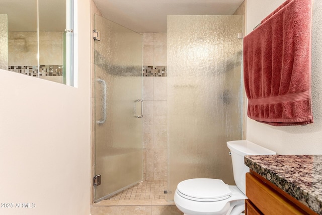 full bathroom featuring toilet, tile patterned floors, vanity, and a shower stall