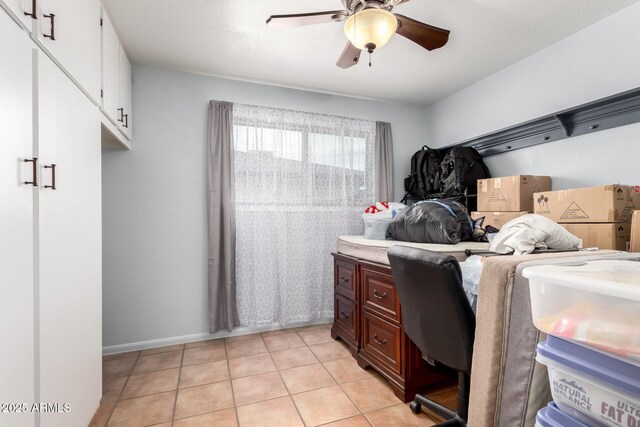 interior space featuring light tile patterned floors and a ceiling fan