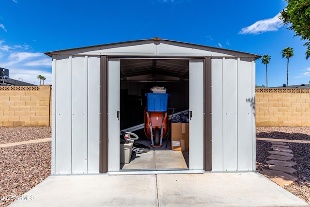 view of shed with fence