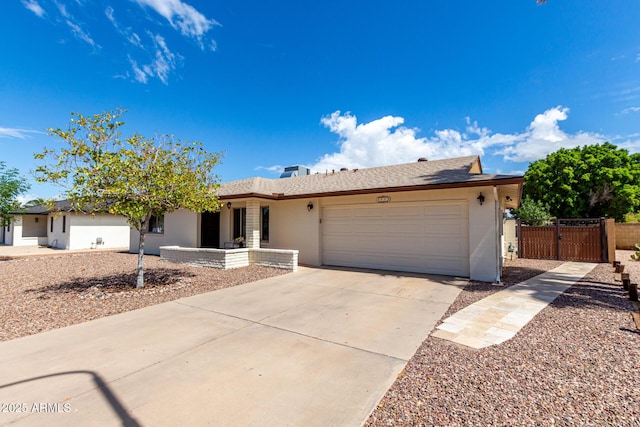 single story home with a garage, driveway, fence, and a gate