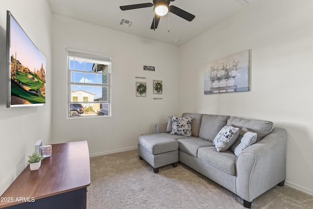 living area featuring a ceiling fan, light colored carpet, visible vents, and baseboards