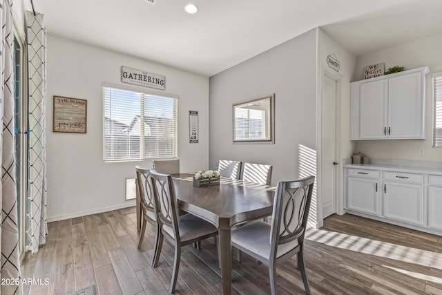 dining area with wood finished floors and baseboards