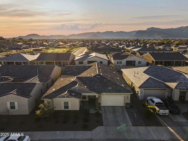 aerial view at dusk with a mountain view and a residential view