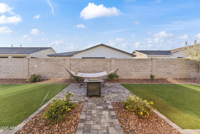 view of yard featuring a patio area, a fire pit, and fence