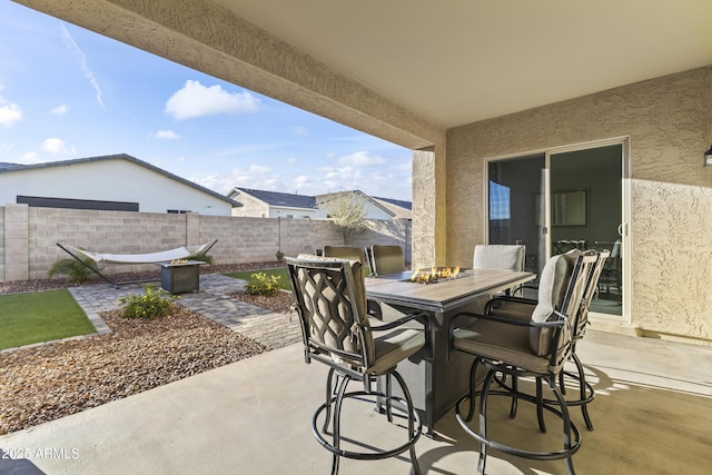 view of patio featuring outdoor dining area and fence