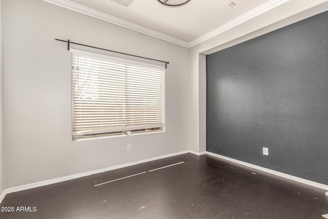 spare room with baseboards, finished concrete floors, crown molding, and a textured wall