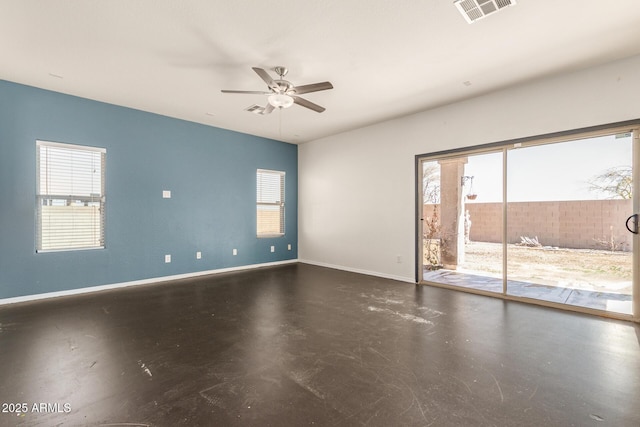 spare room with baseboards, visible vents, a wealth of natural light, and ceiling fan