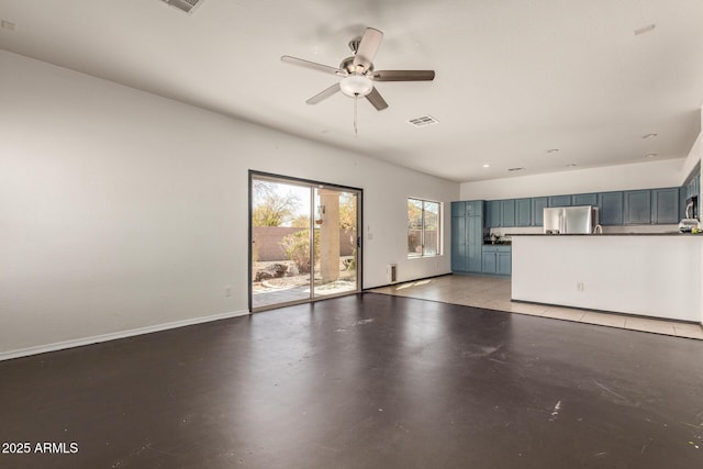 unfurnished living room featuring ceiling fan, visible vents, baseboards, and finished concrete floors