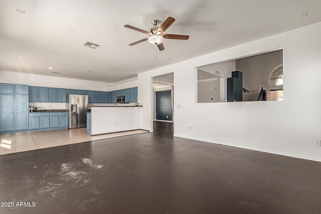 unfurnished living room featuring visible vents, baseboards, finished concrete floors, and a ceiling fan