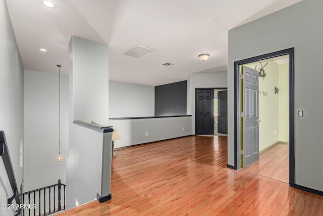 unfurnished room with recessed lighting, baseboards, visible vents, and light wood finished floors