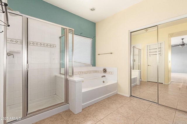 bathroom with tile patterned floors, a stall shower, ceiling fan, and a bath