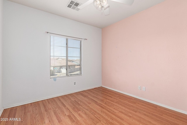 empty room with visible vents, baseboards, light wood-style floors, and a ceiling fan