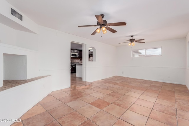 tiled empty room with ceiling fan