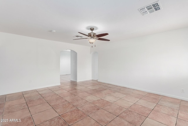 tiled spare room featuring ceiling fan