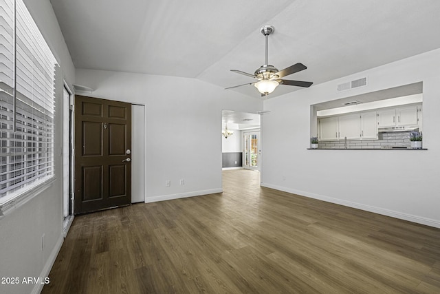 2929 E Broadway Rd Unit 44, Mesa, AZ 85204 - unfurnished living room with a chandelier, ceiling fan, dark wood finished floors, and vaulted ceiling