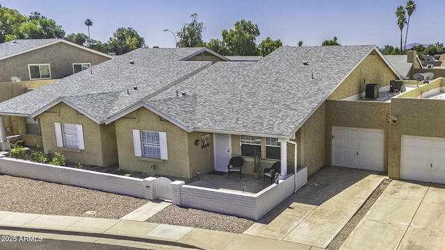 2929 E Broadway Rd Unit 44, Mesa, AZ 85204 - view of front facade featuring roof with shingles, concrete driveway, a gate, a garage, and stucco siding