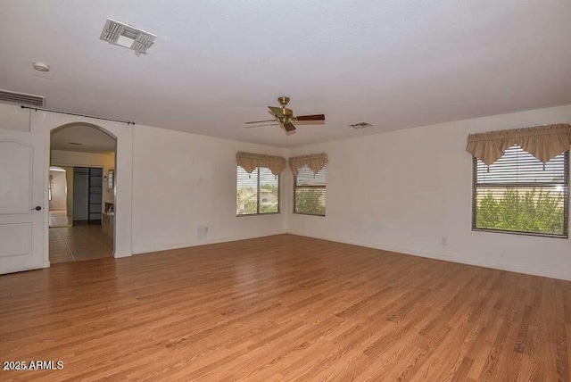 empty room featuring light wood-type flooring and ceiling fan