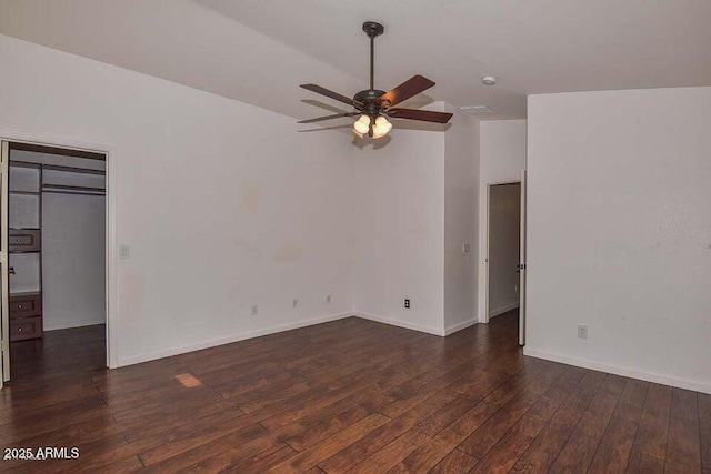 unfurnished room featuring ceiling fan and dark wood-type flooring