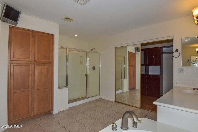 bathroom featuring vanity, independent shower and bath, and tile patterned flooring