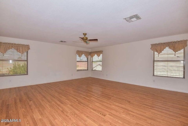 spare room featuring ceiling fan and light hardwood / wood-style floors