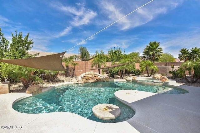 view of swimming pool with an in ground hot tub