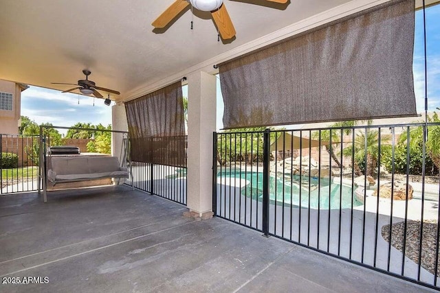 view of patio / terrace with ceiling fan and a fenced in pool