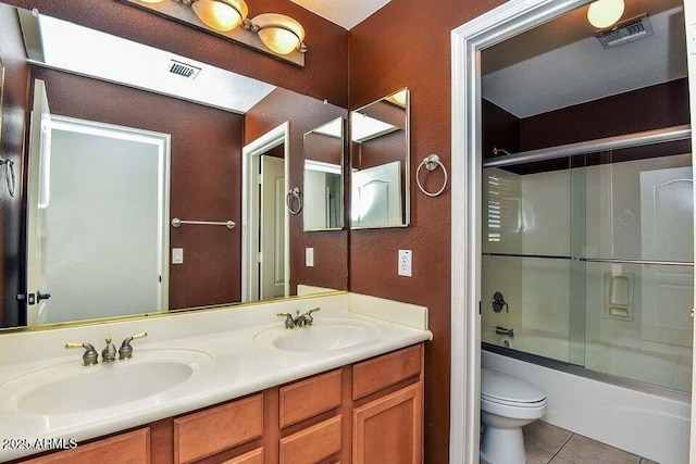 full bathroom with toilet, tile patterned flooring, enclosed tub / shower combo, and vanity