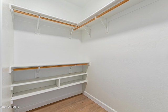 spacious closet with wood finished floors