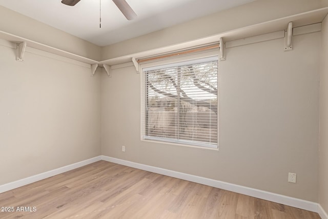 walk in closet with light wood-type flooring and ceiling fan