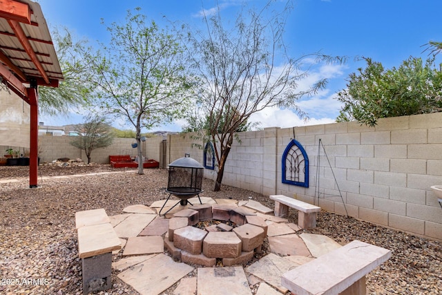 view of patio featuring a fenced backyard and a fire pit