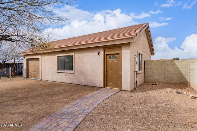 exterior space with a garage, driveway, and fence