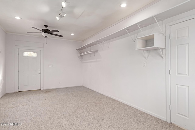 walk in closet with carpet and ceiling fan