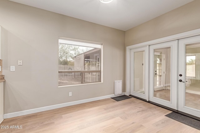 doorway to outside with french doors, wood finished floors, a wealth of natural light, and baseboards