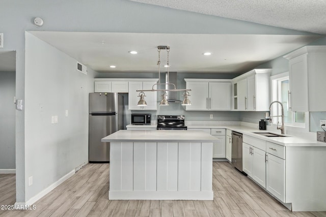 8051 W Mariposa Dr, Phoenix, AZ 85033 - kitchen featuring stainless steel appliances, a sink, wall chimney exhaust hood, light wood-style floors, and white cabinetry