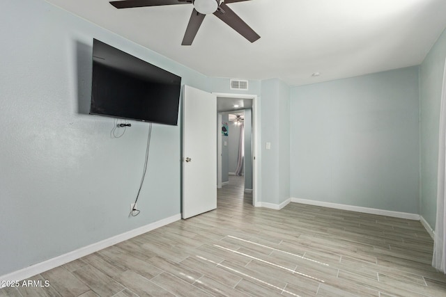 8051 W Mariposa Dr, Phoenix, AZ 85033 - unfurnished bedroom featuring baseboards, light wood finished floors, and ceiling fan